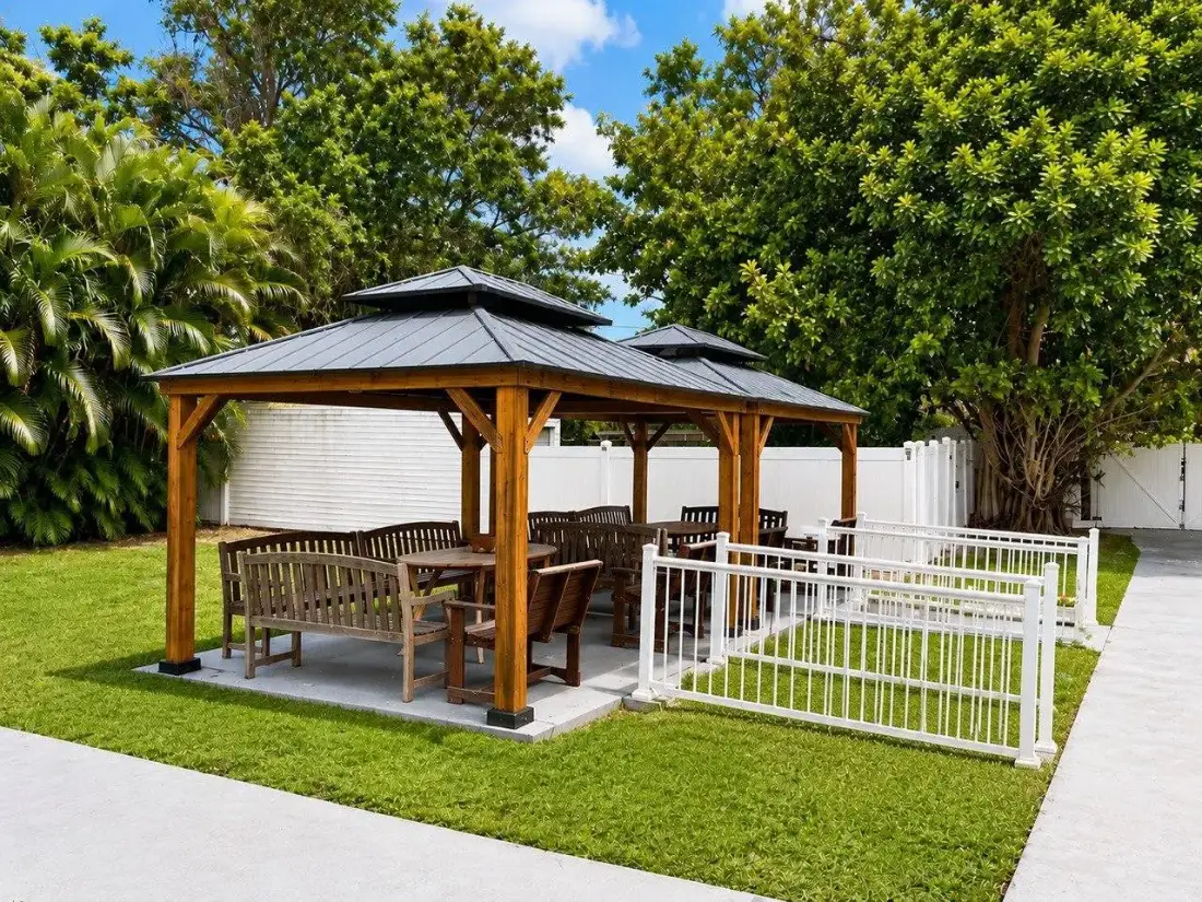 Shaded gazebo with benches in the Bayou Palms courtyard